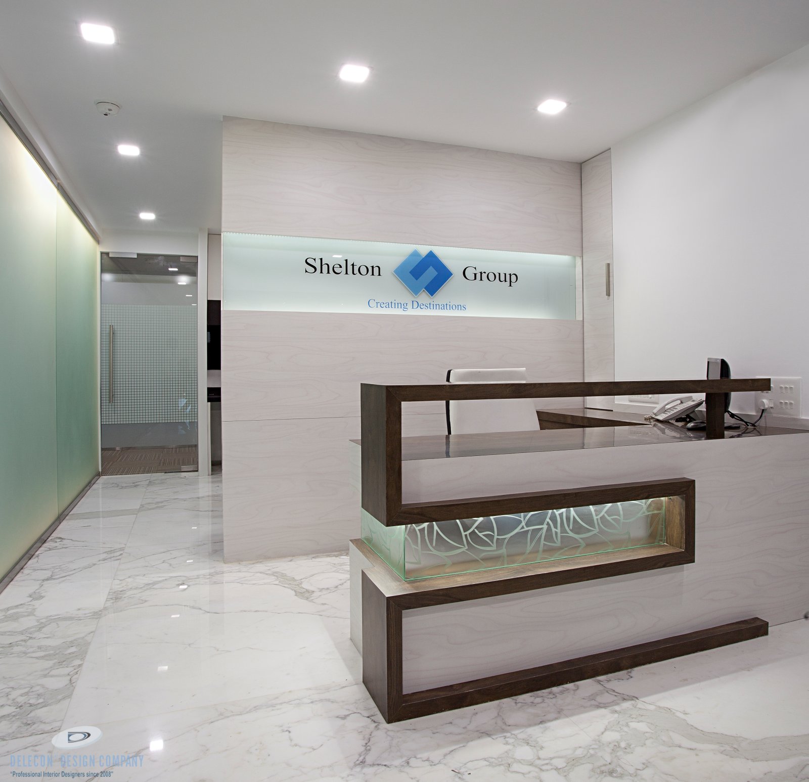 Reception desk and backdrop design at Shelton Group office